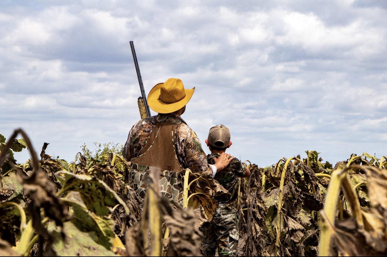 Father and son walking a dove field in the Rio Grande Valley
